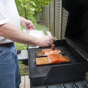 man grilling salmon